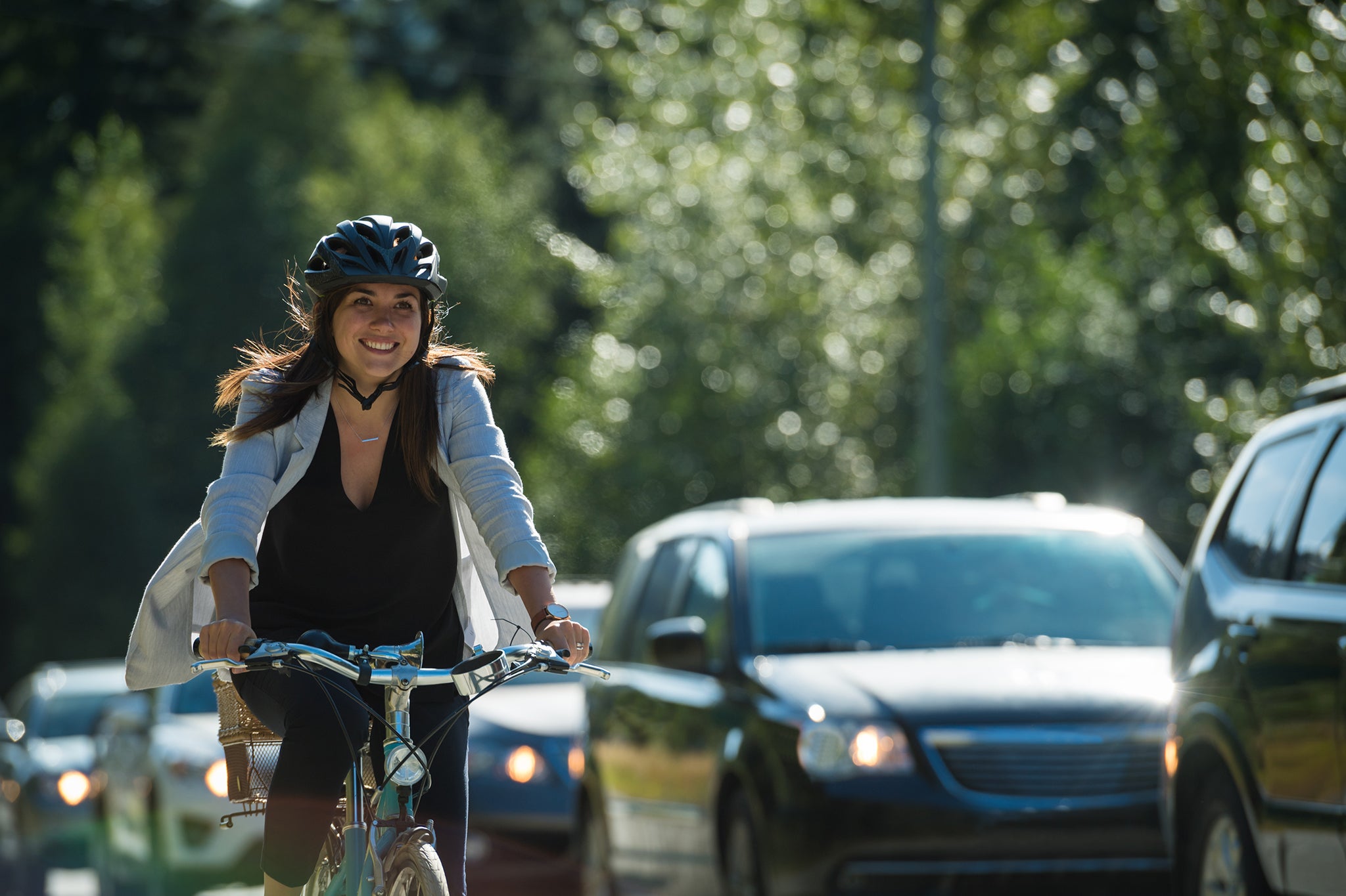 Woman passing traffic on her bike in a cycling lane.