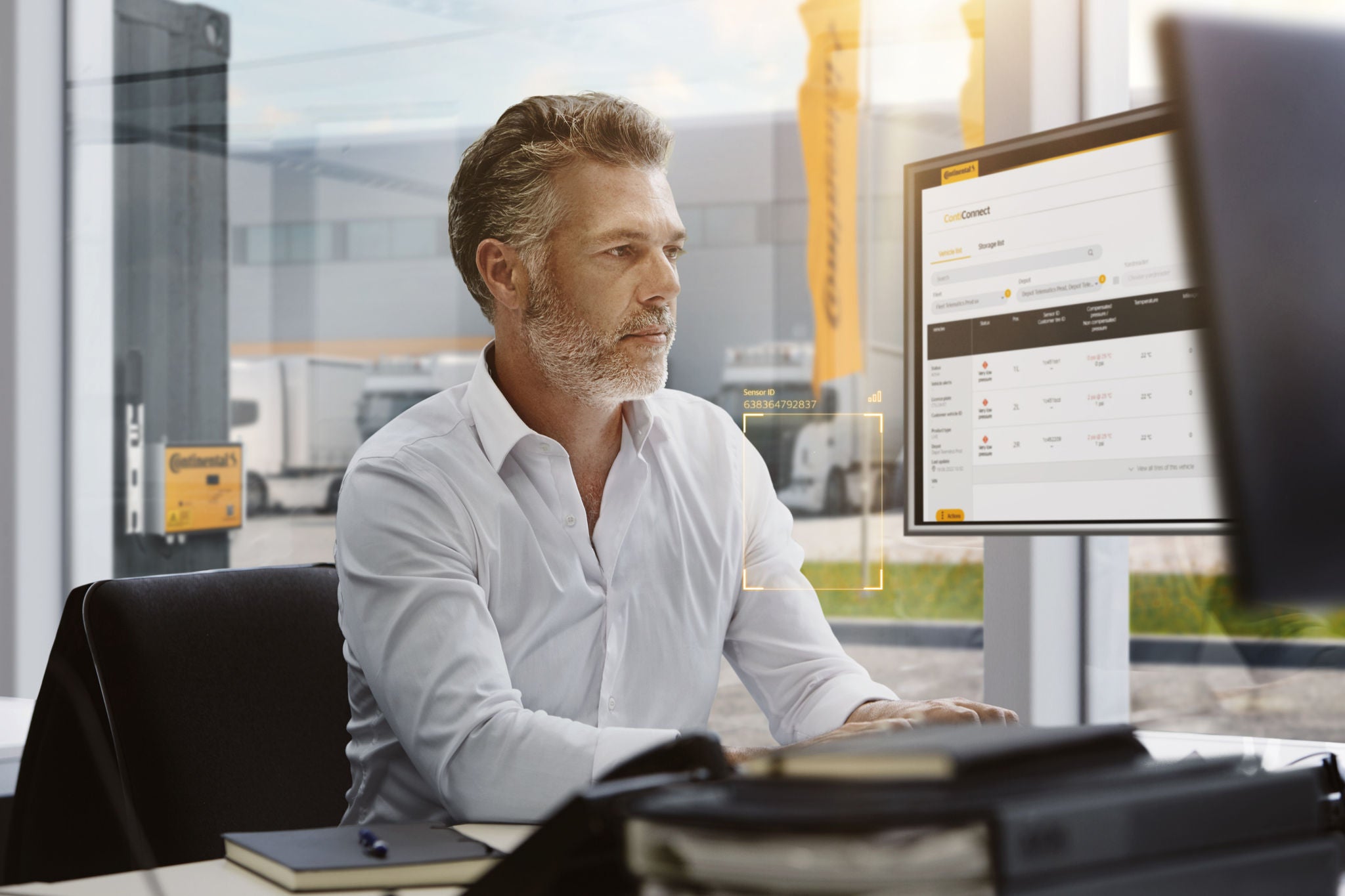 A man sitting at his desk reviewing tire analytics